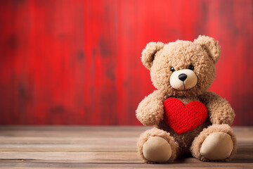 Obraz premium Cute teddy bear with red heart on old wood, copy space, red background. Valentine Concept
