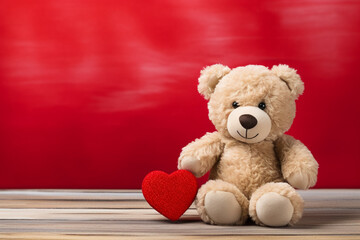 Cute teddy bear with red heart on old wood, copy space, red background. Valentine Concept