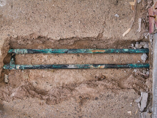 Exposed, leaking copper central heating pipes, badly corroded after being buried in the concrete...