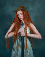 Portrait of a girl wearing a crown of thorns on her head with a sword in a white dress