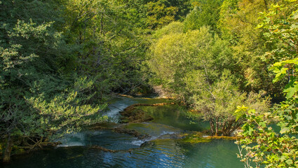 Naklejka premium Travertine pools in the River Una below Milancev Buk waterfall at Martin Brod in Una-Sana Canton, Bosnia and Herzegovina. Located in Una National Park, also known as Veliki Buk or Martinbrodski