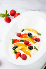 fruit salad with wild berries and strawberries side view