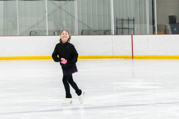 Figure skating practice at an indoor skating rink