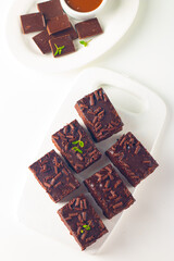 Delicious chocolate brownies with mint on white background. Sweet cake concept. 