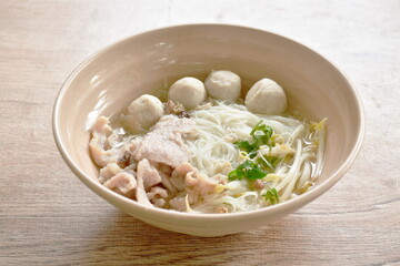 boiled white vermicelli noodles with soft slice pork and ball in clear soup on bowl 