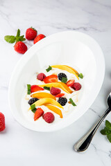 fruit salad with wild berries and strawberries side view