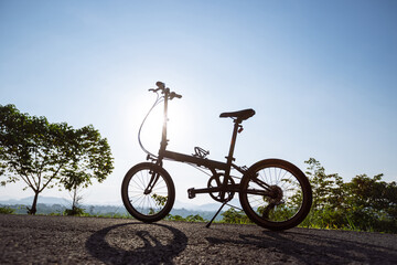A folding bike on sunrise mountain top road