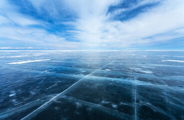 Harsh winter landscape of lifeless endless icy desert of frozen sea and beautiful layered clouds...