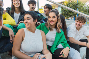 Smiling group of friends sitting on stairs