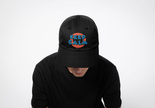 Mockup of man wearing customizable cap in studio looking down