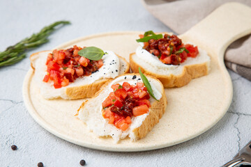 bruschetta with tomatoes and labneh cheese on a light background side view