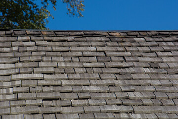 Texture of wooden tile roof and a part of blue sky