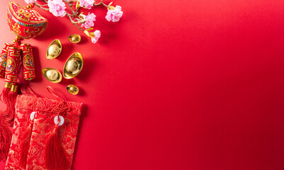 Chinese new year decorations made from red packet, orange and gold ingots or golden lump on a red...