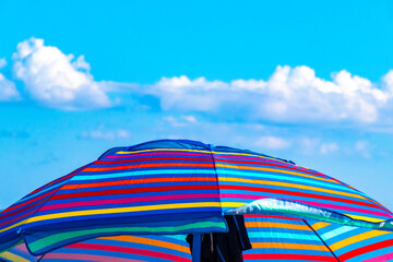 Colorful parasol with many colors on the Caribbean beach in Mexico.