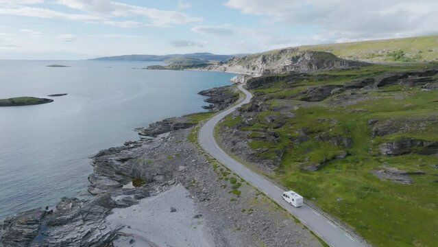 Camper Van Driving On A Winding Road In Summer In Northern Norway