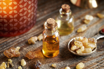 Frankincense essential oil in a transparent bottle with boswellia resin