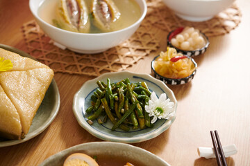 Vietnamese style green beans on dinner table next to other appetizers