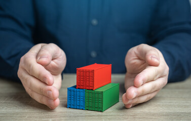 Man protects shipping containers with his hands. Security, reliability, and protection of the...