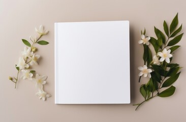 a white blank book surrounded by green leaves - Powered by Adobe