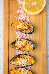 oysters scallops with red sea salt and citric acid on a wooden tray top view