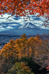 Mount Fuji seen from the Chureito Pagoda and Arakura Sengen Shrine overlooking Fujiyoshida city, Yamanashi Prefecture. Taken in Autumn with Japanese maple trees adding color.