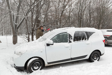 Cleaning a car after a snow blizzard