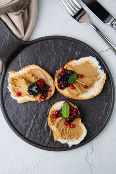 canapes with pate, mint leaves and berries, top view