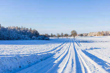 Fototapeta na wymiar Snowy winter road in the countryside