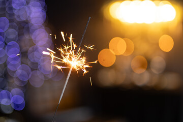 sparklers close-up on a blurred background of garlands