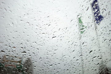 View on flags through wet windshield with rain drops.