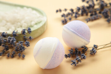 Natural cosmetics. Handmade lavender bath bombs and lavender flowers on beige background.