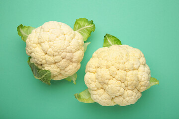 Fresh organic cauliflower on mint background. Flat lay
