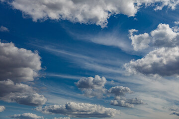 White fluffy clouds and bright sun on dark blue sky.Sky blue or azure sky and clouds is bright white background.
