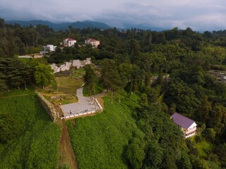 Wide aerial panoramic view scenic Black Sea coast flora with calm seashore in summer. Petra Fortress parking. Tsikhisdziri Georgia