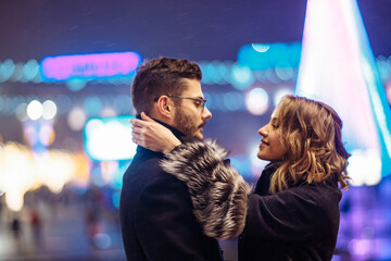 couple in love in winter during the Christmas holidays on a date in the city in winter clothes. Love and relationships in winter.