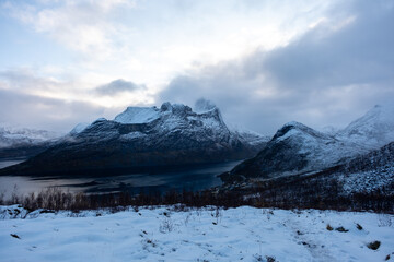 Snowy mountain hike up Segla in Senja, Norway.  Snowcapped mountains in the Arctic Circle of Northern Norway.  Famous hike on Senja island.  Shot in October