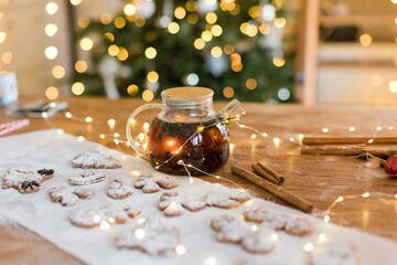 Glass teapot and cookies on table
