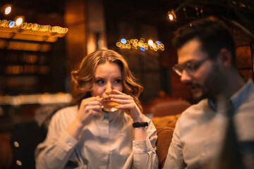 soft focus photo, a couple in love in a cafe sitting on the sofa and drinking tea