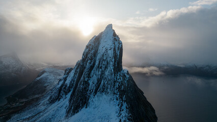 Aerial drone photo of snowy mountain hike up Segla in Senja, Norway.  Snowcapped mountains in the...