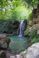 Fototapeta na wymiar Vertical image of Blederije waterfall Serbia, secret spot in the wild woods.