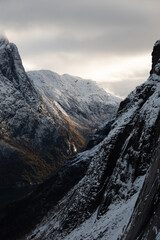 Snowy mountain hike up Segla in Senja, Norway.  Snowcapped mountains in the Arctic Circle of Northern Norway.  Famous hike on Senja island.  Shot in October - obrazy, fototapety, plakaty