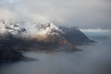 Aerial of beautiful Norwegian fjords with snowcapped mountains.  Located in the far northern...