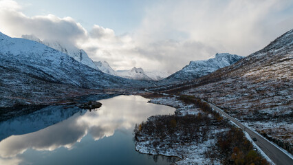 Aerial photo of a calm Norwegian mountain alpine lake in the Winter in the Arctic Circle of Norway....