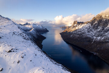 Aerial of beautiful Norwegian fjords with snowcapped mountains.  Located in the far northern reaches of Norway in the arctic circle.  Shot on a DJI drone.