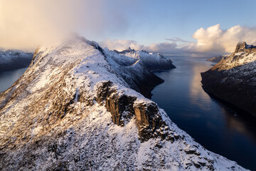 Aerial of beautiful Norwegian fjords with snowcapped mountains.  Located in the far northern reaches of Norway in the arctic circle.  Shot on a DJI drone.