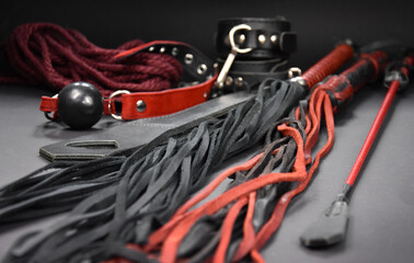 Leather flogger whip sex toys on a dark background stock photo images. Set of erotic toys for BDSM...