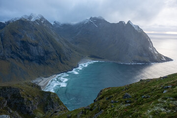 Obraz premium Kvalvika Beach at sunset in Lofoten, Norway in the Arctic Circle. One of Norway's most beautiful beaches. with tower cliffs and large waves.