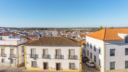 Fototapeta na wymiar View over clay bricks roof tops the with clear blue sky on a sunny day of old town of Evora, Alentejo, Portugal