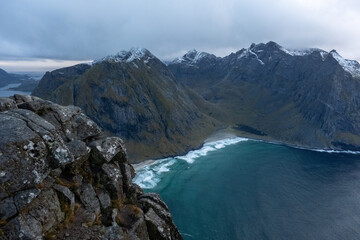 Obraz premium Kvalvika Beach at sunset in Lofoten, Norway in the Arctic Circle. One of Norway's most beautiful beaches. with tower cliffs and large waves.