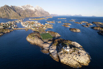 Aerial of Henningsvaer fishing village with soccer field on island.  Located in the Arctic circle...